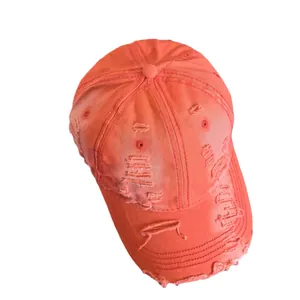 Distressed orange canvas baseball cap with vintage washed finish and torn fabric details