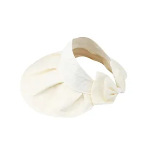 Women's cream sun visor with wide brim and elegant back bow detail in textured fabric