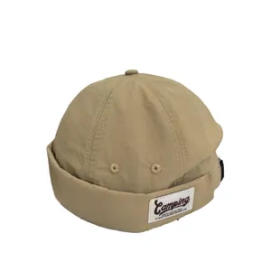 Khaki docker hat with vintage camping patch and metal eyelets for street style