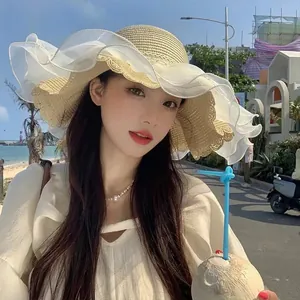 Women's straw sun hat with large wavy lace brim for beach vacation and UV protection