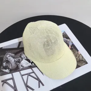 Detail of light yellow woven baseball cap with breathable texture on a magazine