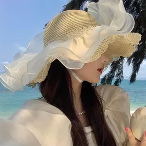 Women's wide brim straw sun hat with white lace wavy edge for beach vacation
