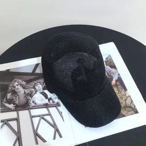 Top view of a breathable black mesh baseball cap on a magazine with a hollow knit texture