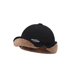 Thick winter trapper hat in black with brown faux shearling and Never Give Up embroidery