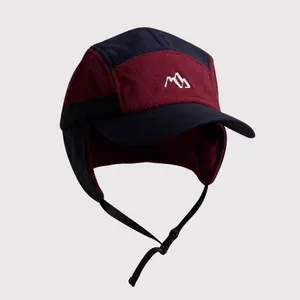 Detail of color-block fleece trapper hat with ear flaps and mountain embroidery