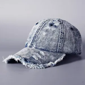 Distressed vintage washed denim baseball cap with frayed edges and acid-washed finish