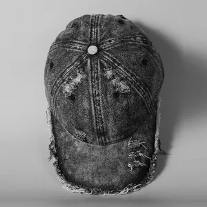 Distressed acid wash denim baseball cap with frayed edges and vintage streetwear aesthetic