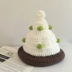 Handmade knitted Christmas tree hat for women featuring festive pom-pom decorations