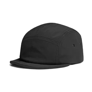 Detail of black ripstop camper hat with metal side eyelets and flat brim construction
