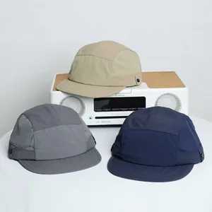 Detail of lightweight quick-dry 5-panel caps in khaki, navy, and dark grey for outdoors