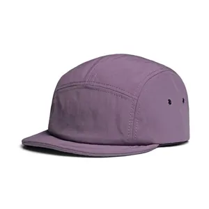 Detail view of purple 5-panel camper hat showing metal eyelets and textured fabric
