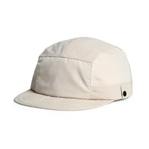 Detail view of cream five-panel camper cap featuring breathable mesh panels and side buckle