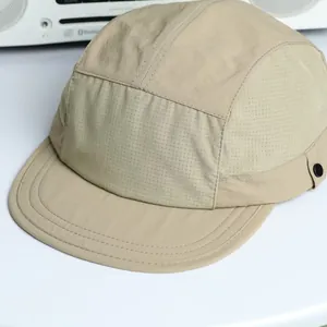 Detail view of khaki 5-panel outdoor cap showing lightweight ripstop nylon fabric texture