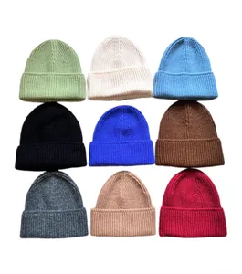 Colección de nueve gorros de punto acanalados de colores en verde salvia crema azul y más
