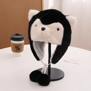 Detail of plush panda earflap hat with black and white faux fur and soft pom-poms