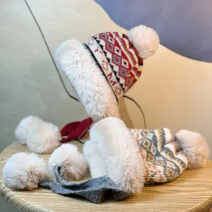 Detail view of winter knit trapper hat showing thick faux fur lining and pom-poms