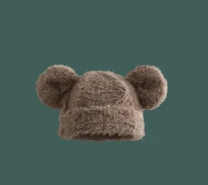 Detailed view of plush brown beanie with cute round ears and soft fuzzy faux fur texture