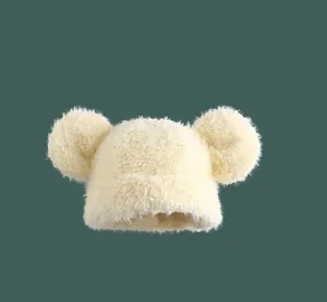 Detail of soft cream plush knit hat with cute bear ears and thick fuzzy texture