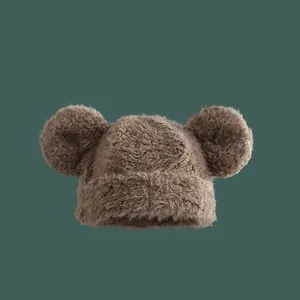 Plush knitted winter hat with cute bear ears in warm brown for outdoor warmth