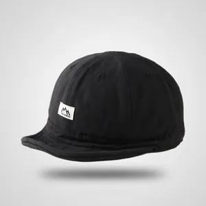 Classic black cotton soft-top baseball cap with short brim and mountain graphic woven label