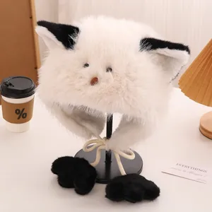 Detail of plush cat ear hat with black paw pom-poms and soft white faux fur texture