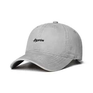Detailed side view of a gray washed cotton baseball cap featuring black script embroidery