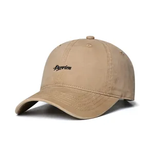 Detailed close-up of Pyevten black letter embroidery on khaki washed cotton baseball cap
