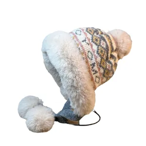 Winter faux fur trapper hat with geometric pattern and white pom poms for women