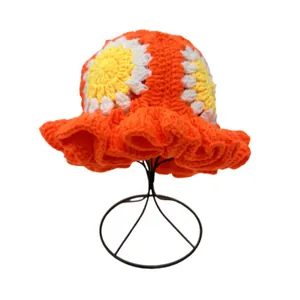 Detail of crochet bucket hat with sunflower pattern and ruffled brim design