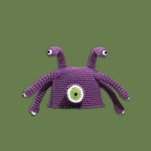Funny purple knitted octopus hat with large cartoon eye and 3D tentacles for winter warmth