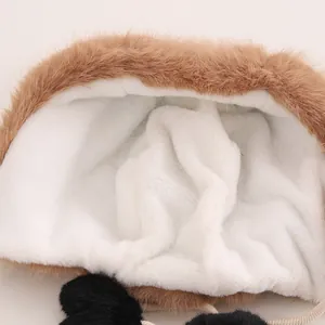 Detail view of winter hat with thick white plush lining and brown faux fur exterior