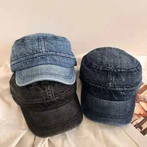 Detailed texture of flat top denim hats in light blue, dark blue and black wash