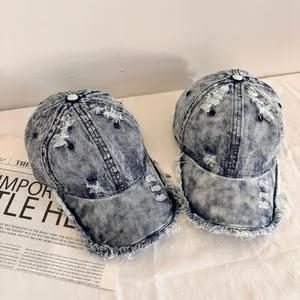 Distressed vintage denim baseball caps with frayed edges and street style washed finish