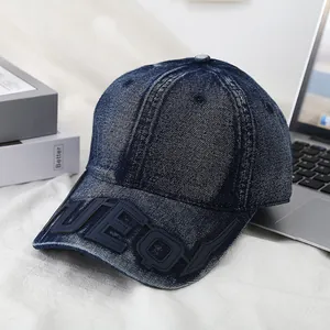 Navy blue washed denim baseball cap with UEQI letter embroidery in a stylish setting
