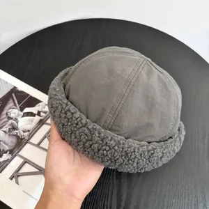 Detail of dark grey docker hat featuring premium sherpa fleece lining and texture