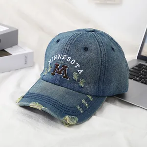 Distressed denim baseball cap with embroidered M letter and Minnesota text in light blue