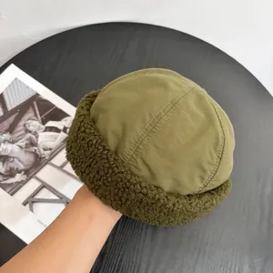 Detail of olive green miki hat with sherpa trim and durable canvas stitching detail