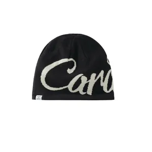 Detail shot of the white Care jacquard lettering on the black knitted winter beanie