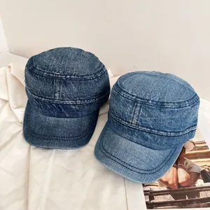 Detailed macro view of vintage washed denim cadet caps in dark and light blue colors