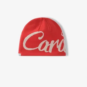 Detail of red knit beanie featuring white jacquard lettering and soft texture