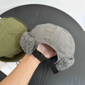 Detailed view of the warm lamb wool lining and adjustable buckle strap of the winter aviator hat