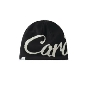 Black knit earflap beanie with white script lettering and a woven side label
