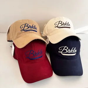Collection of four vintage baseball caps in khaki, beige, burgundy, and navy with embroidery
