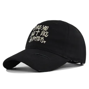 Close-up of cross embroidery and distressed brim on black vintage baseball cap