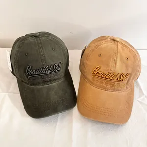 Vintage washed cotton baseball caps in olive and khaki with 3D letter embroidery