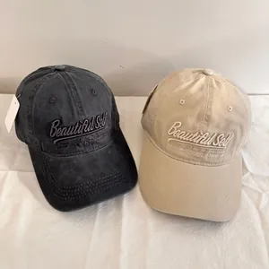 Washed cotton baseball caps in charcoal and khaki with 3D embroidery and tags