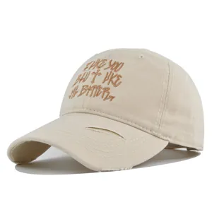 Close-up of distressed brim and 3D embroidery on a vintage style baseball cap