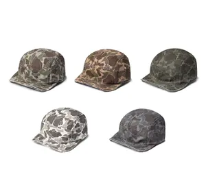 Detail showing five-panel camo camp caps with vintage military prints and metal eyelets