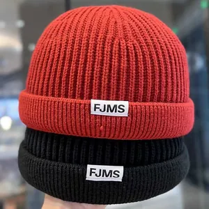 Unisex ribbed knit docker hats in red and black with FJMS woven label detail