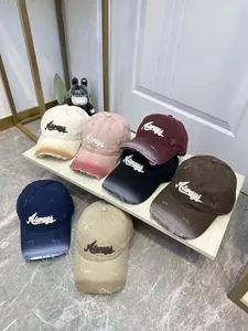 Close-up of distressed baseball caps with Always embroidery and vintage frayed edges